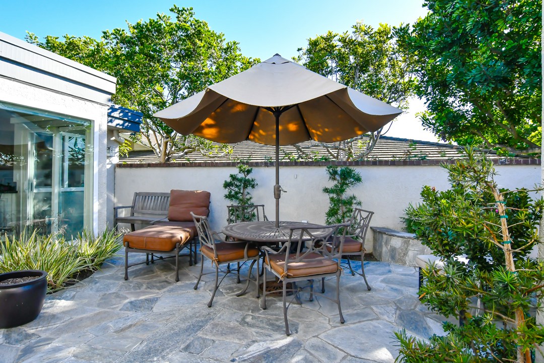 26 Shoal Drive Corona del Mar, CA 92625 - Photo 5 of 37 a view of a table and chairs under an umbrella in the patio