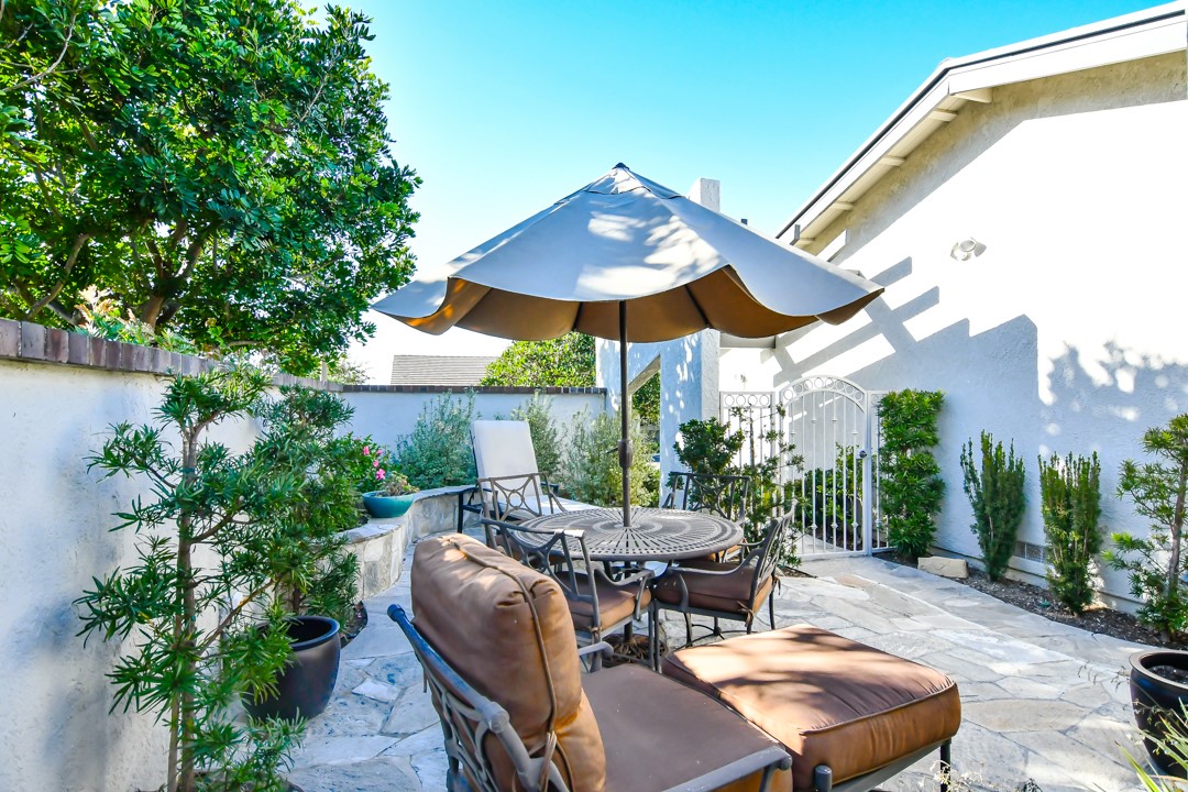 26 Shoal Drive Corona del Mar, CA 92625 - Photo 6 of 37 a view of a patio with a table and chairs under an umbrella
