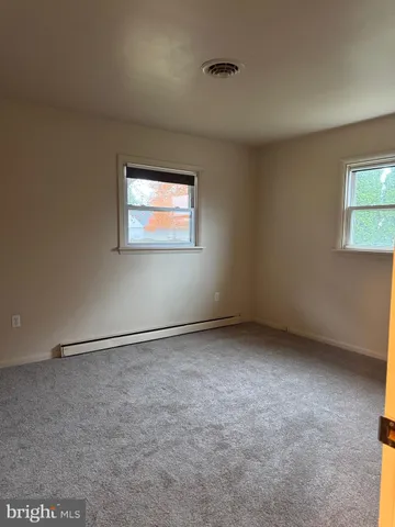 an empty room with a empty space and windows