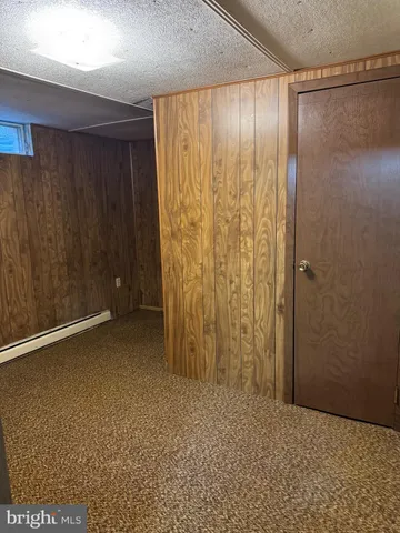 a view of an empty room with a wooden door