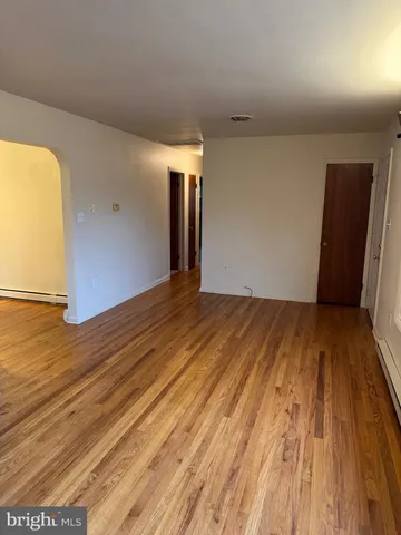 a view of a room with wooden floor