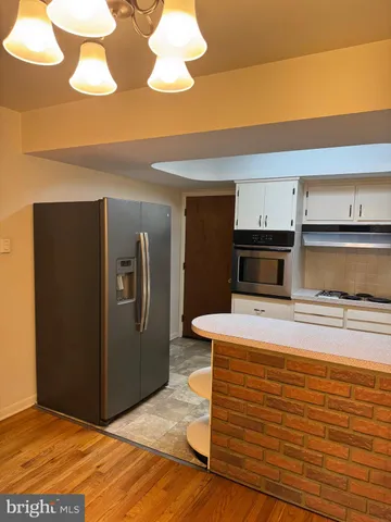 a view of kitchen with wooden floor