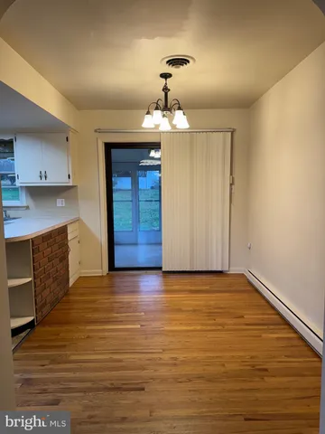 wooden floor in an empty room with a fireplace