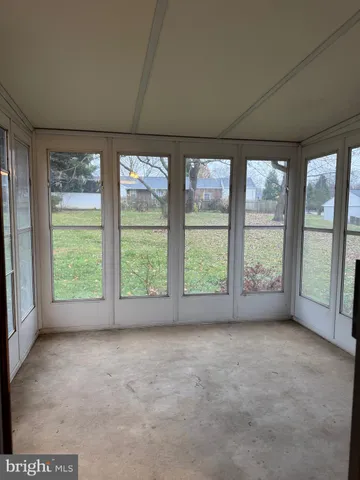 an empty room with large windows
