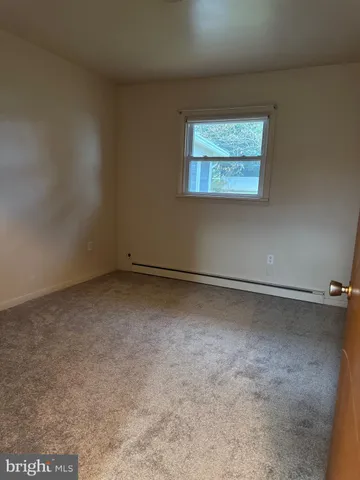 a view of a room with rack on the wall and a window