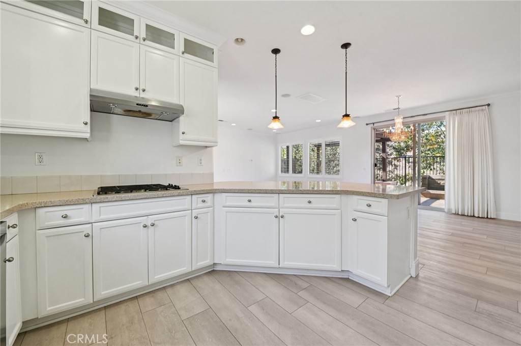 21 Canoe Irvine, CA 92618 - Photo 11 of 61 a kitchen with stainless steel appliances granite countertop a stove a sink and white cabinets with wooden floor