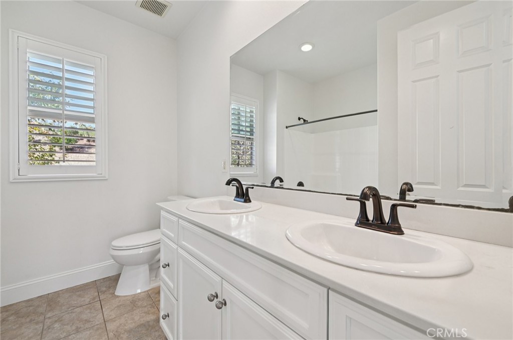 21 Canoe Irvine, CA 92618 - Photo 13 of 61 a bathroom with a sink toilet and a mirror