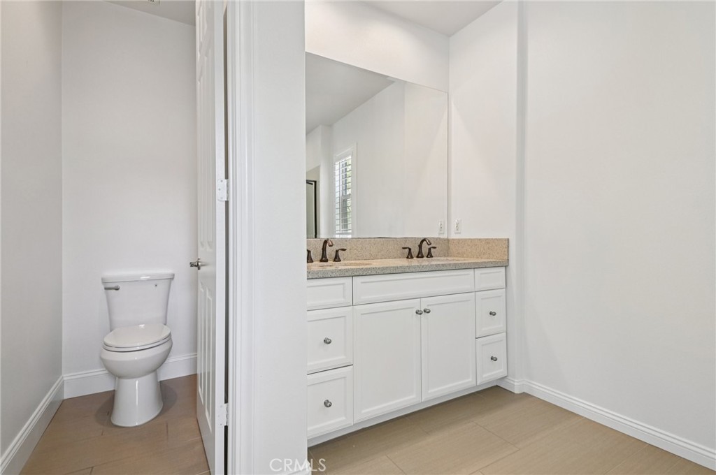 21 Canoe Irvine, CA 92618 - Photo 38 of 61 a spacious bathroom with a granite countertop toilet a sink and a mirror