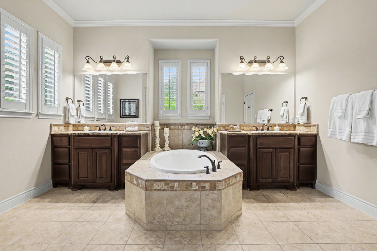 809 Prairie Dunes Drive Georgetown, TX 78628 - Photo 17 of 40 Indulge in a primary bathroom featuring a soaking tub, dual vanities, and ample natural light.