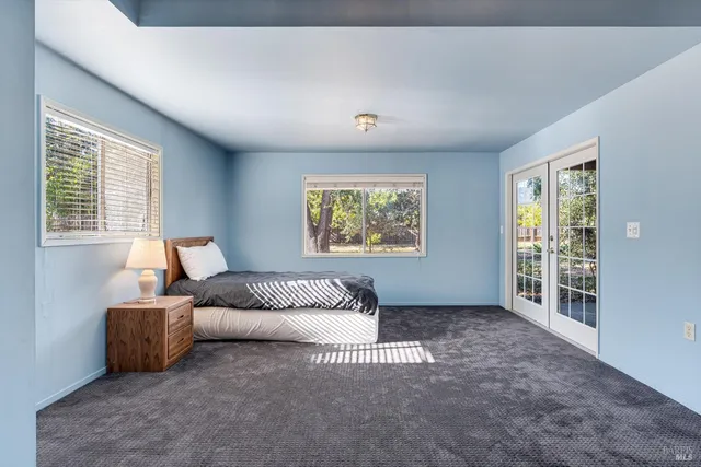 a backyard of a house with basket ball court and outdoor seating