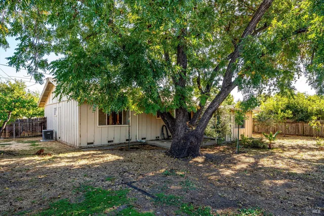 a man walking down a street next to a building