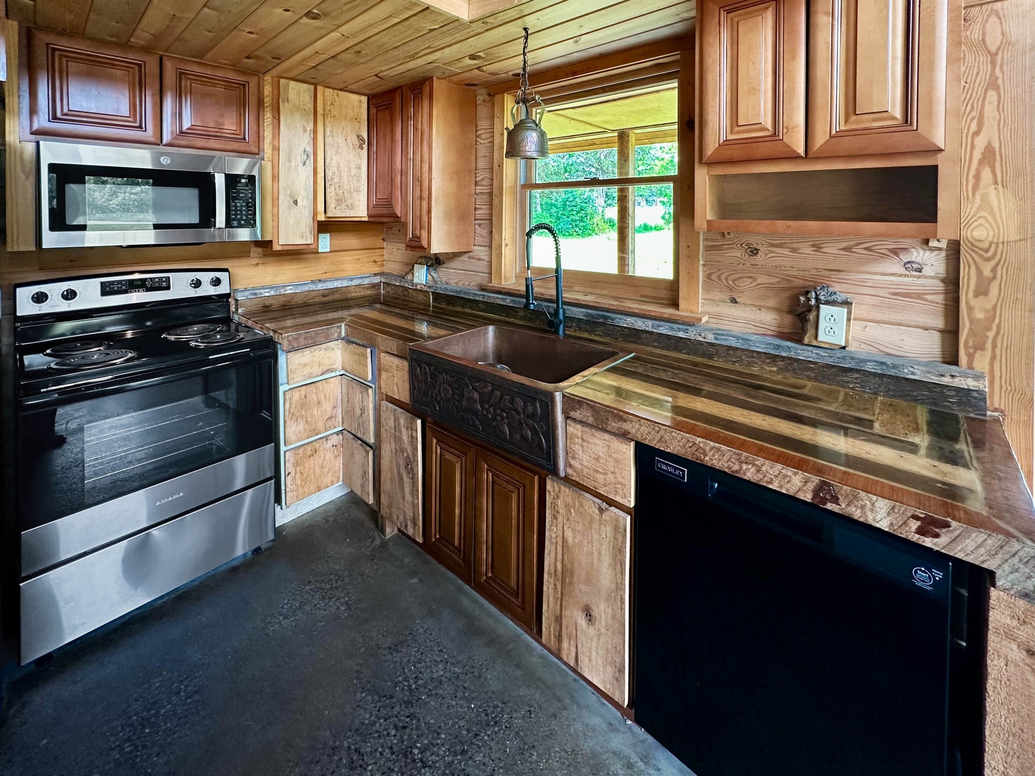 3172 Highway 76 Portland, TN 37148 - Photo 12 of 49 a kitchen with stainless steel appliances a stove sink microwave and cabinets