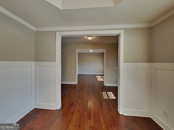 an empty room with wooden floor and closet