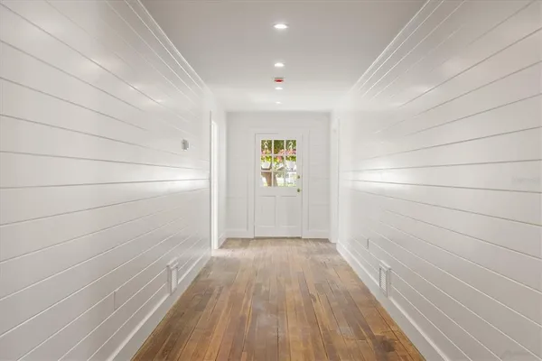 a view of hallway with wooden floor