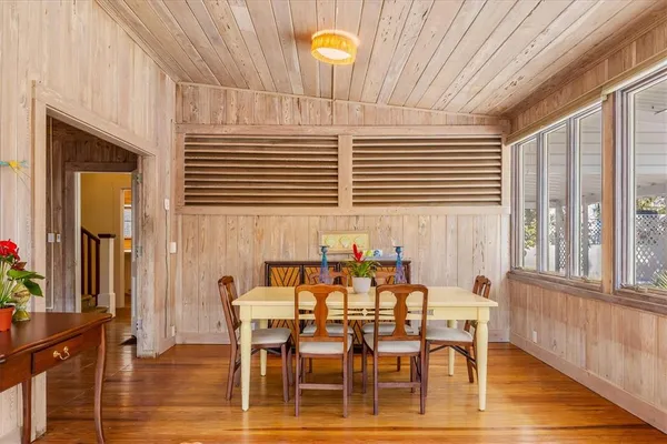 a dining room with furniture and wooden floor