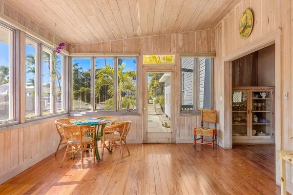 a dining room with furniture and wooden floor
