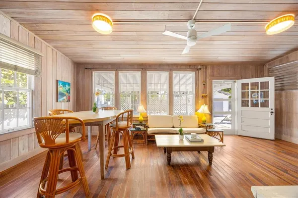 a living room with dining room and wooden floor