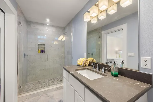 a bathroom with a granite countertop sink a toilet and a mirror