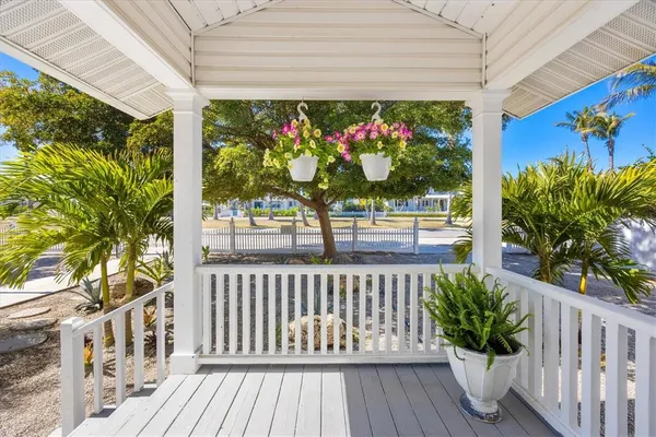 a view of a chairs and table in the balcony