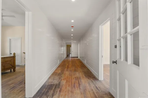 a view of hallway with wooden floor
