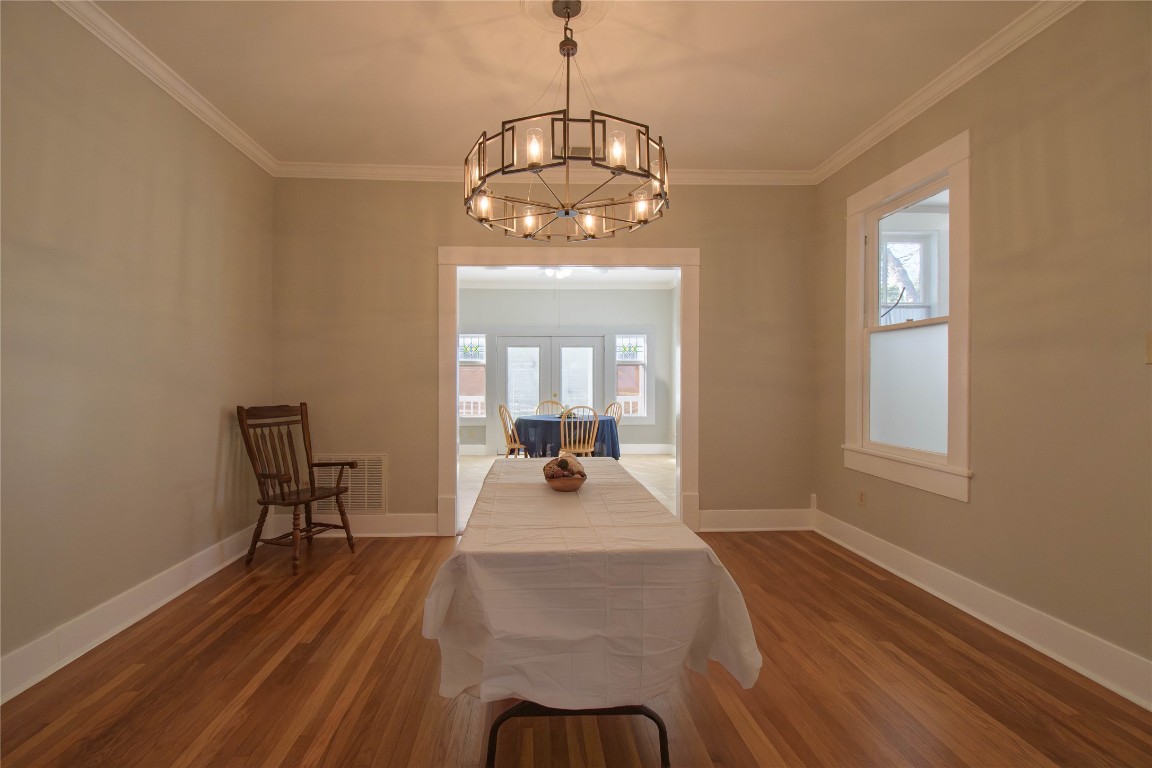 307 Walnut Drive East Austin, TX 78753 - Photo 14 of 34 a dining room with wooden floor a chandelier a wooden table and chairs