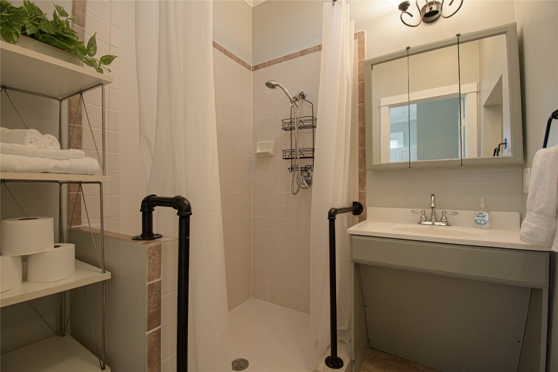 307 Walnut Drive East Austin, TX 78753 - Photo 18 of 34 a bathroom with a sink a mirror a vanity and shower