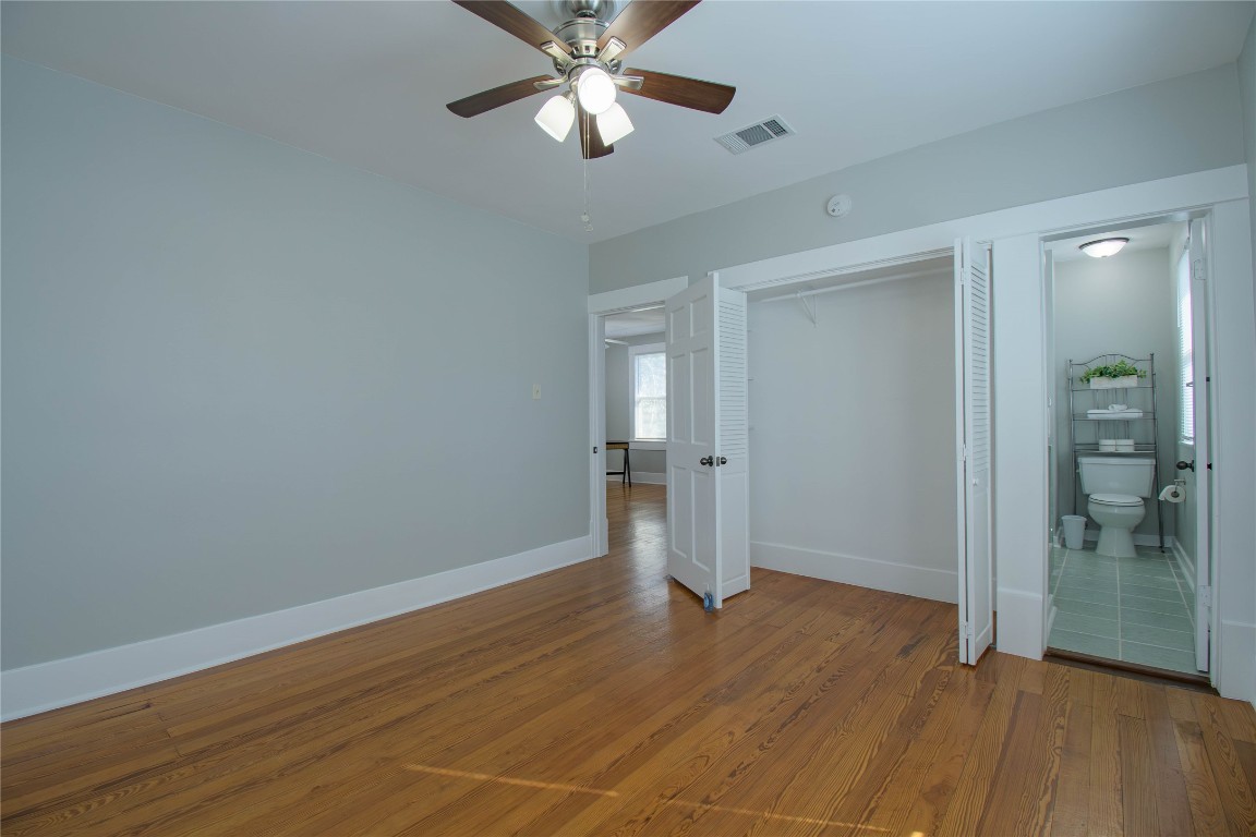 307 Walnut Drive East Austin, TX 78753 - Photo 28 of 34 an empty room with wooden floor and door