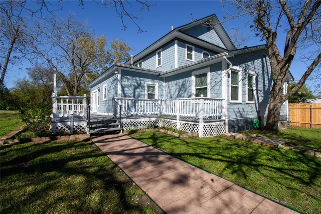 a front view of a house with a yard table and chairs