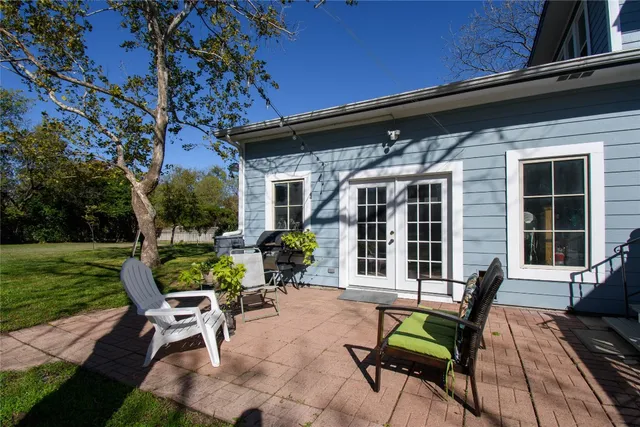 a view of a house with backyard sitting area and garden