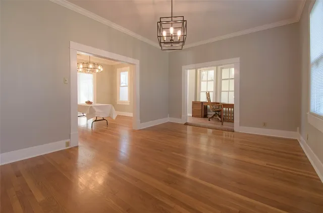 a view of a livingroom with wooden floor and a window