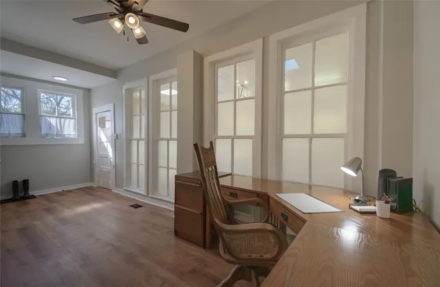 a view of a workspace with furniture and a window