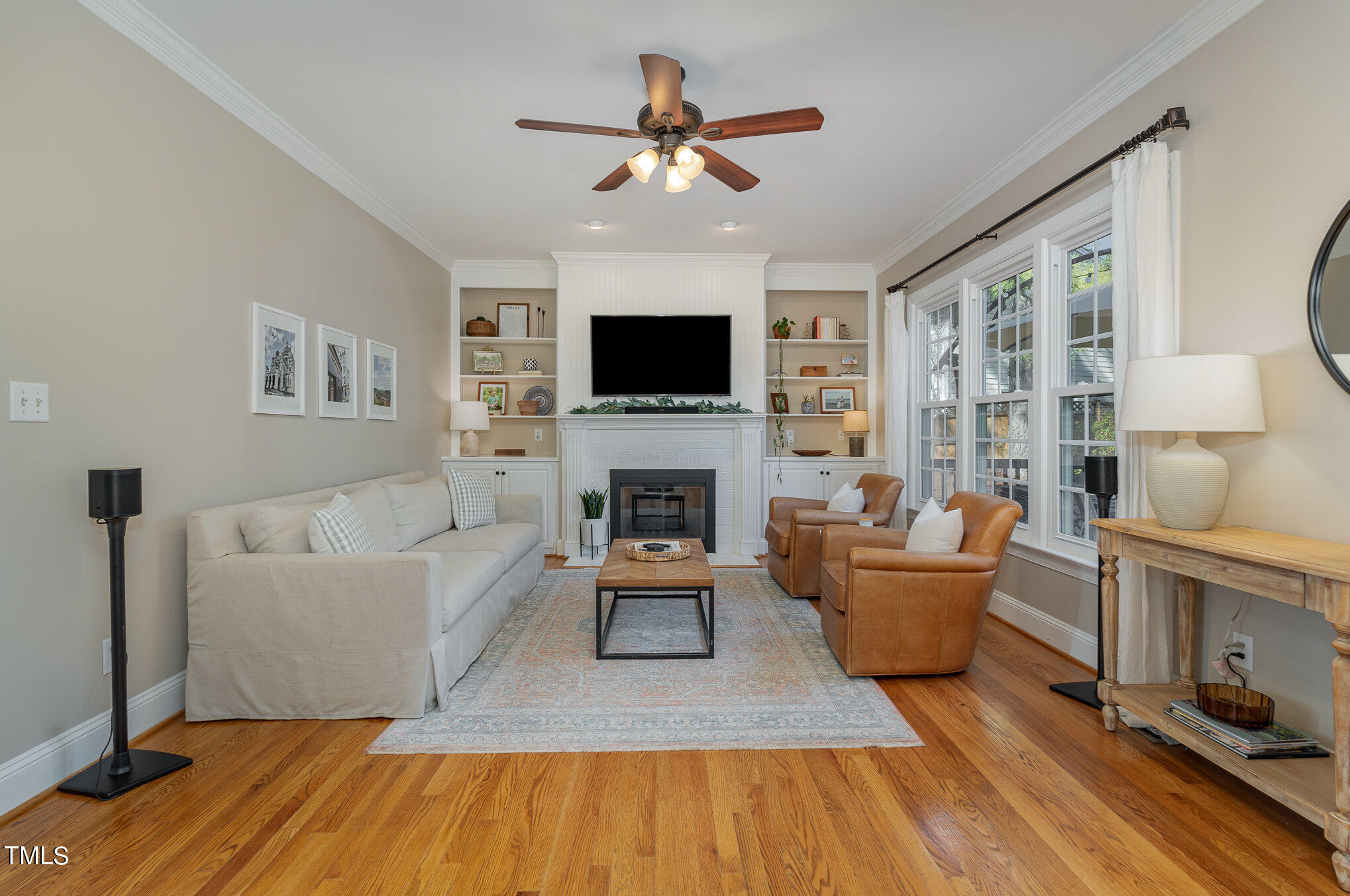 2500 Harptree Court Raleigh, NC 27613 - Photo 14 of 44 a living room with furniture fireplace and a flat screen tv