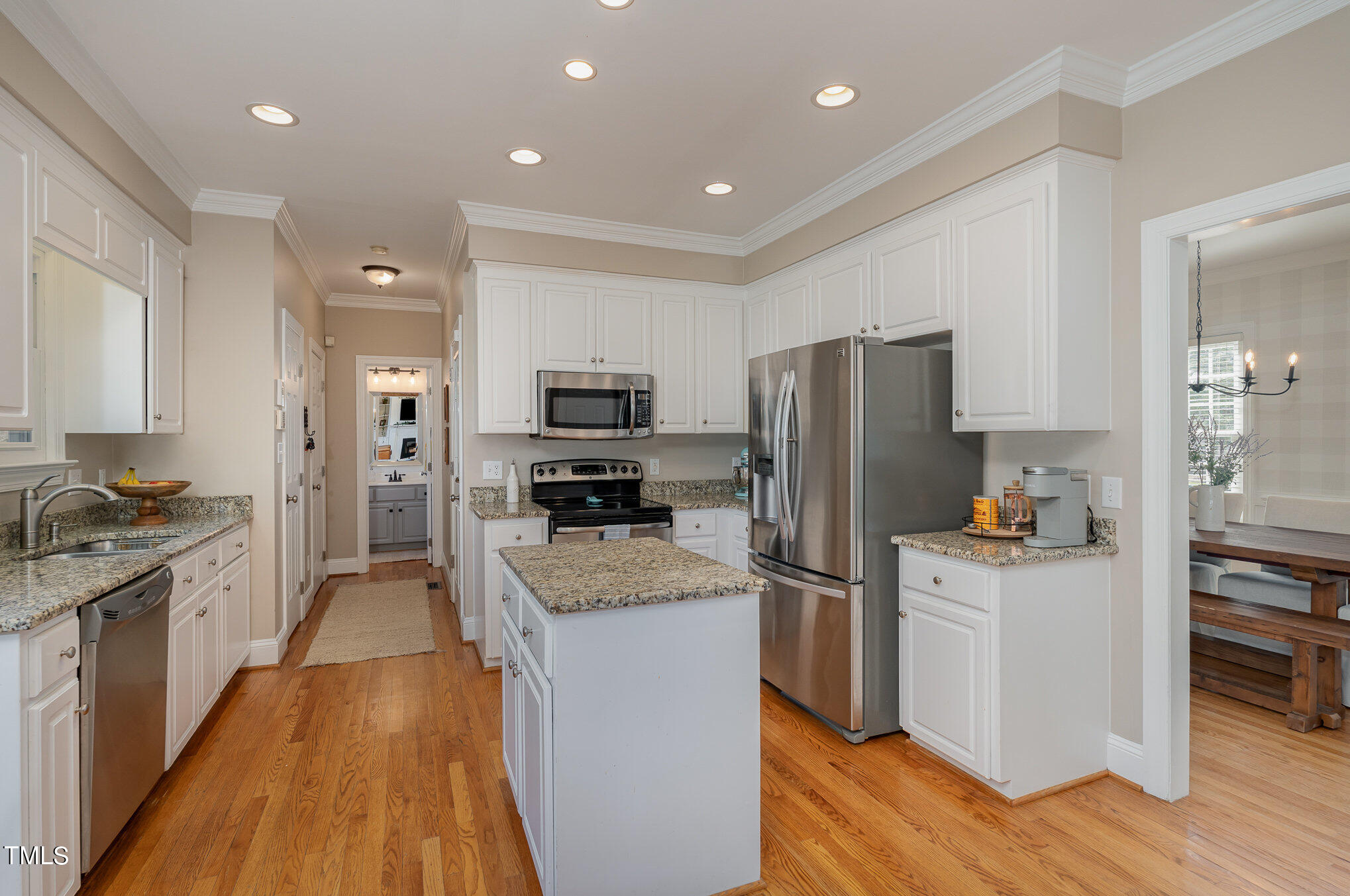 2500 Harptree Court Raleigh, NC 27613 - Photo 16 of 44 a kitchen with refrigerator a microwave and wooden floor