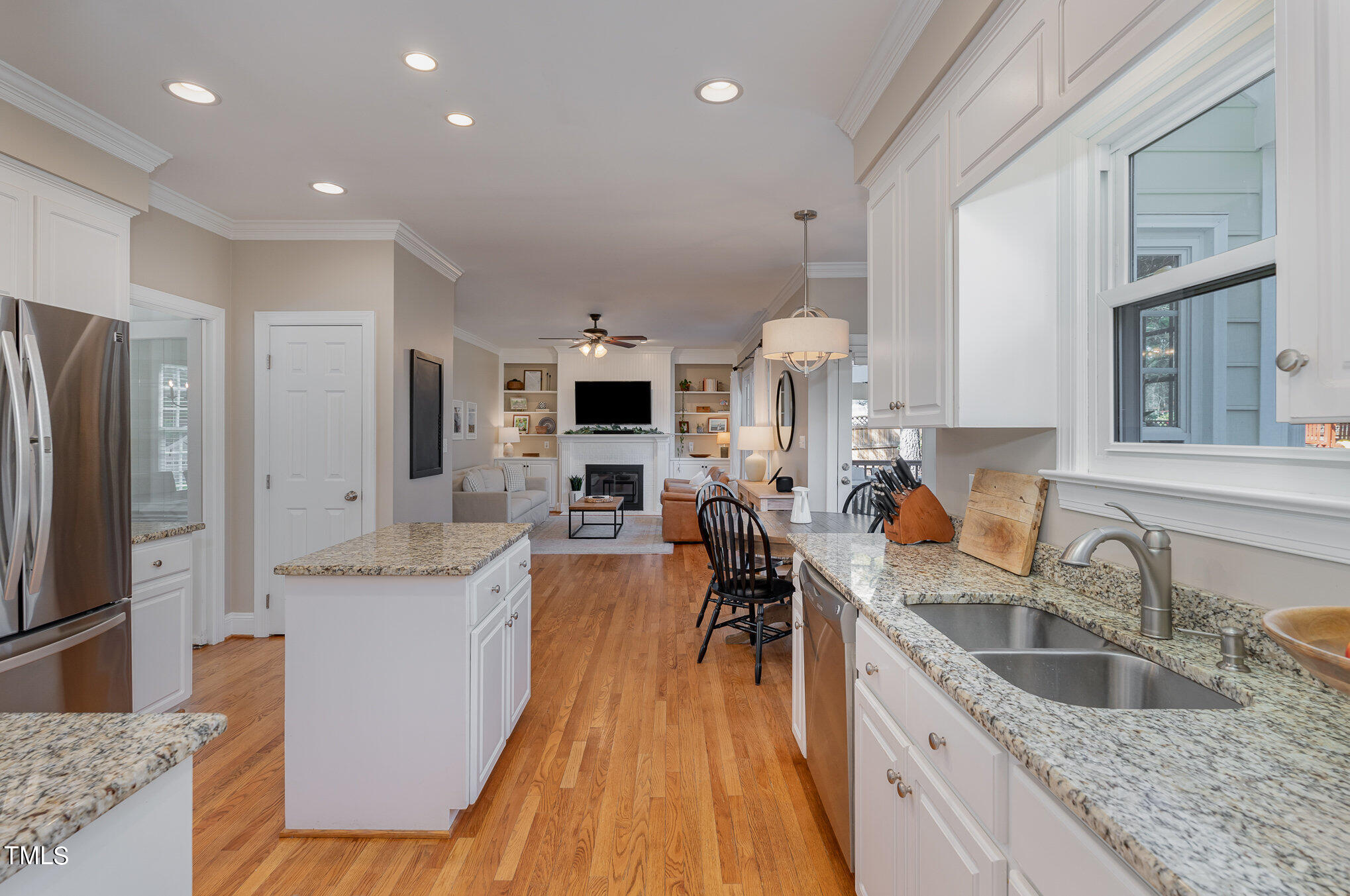 2500 Harptree Court Raleigh, NC 27613 - Photo 18 of 44 a kitchen with granite countertop a sink a counter top space stainless steel appliances cabinets and a large window
