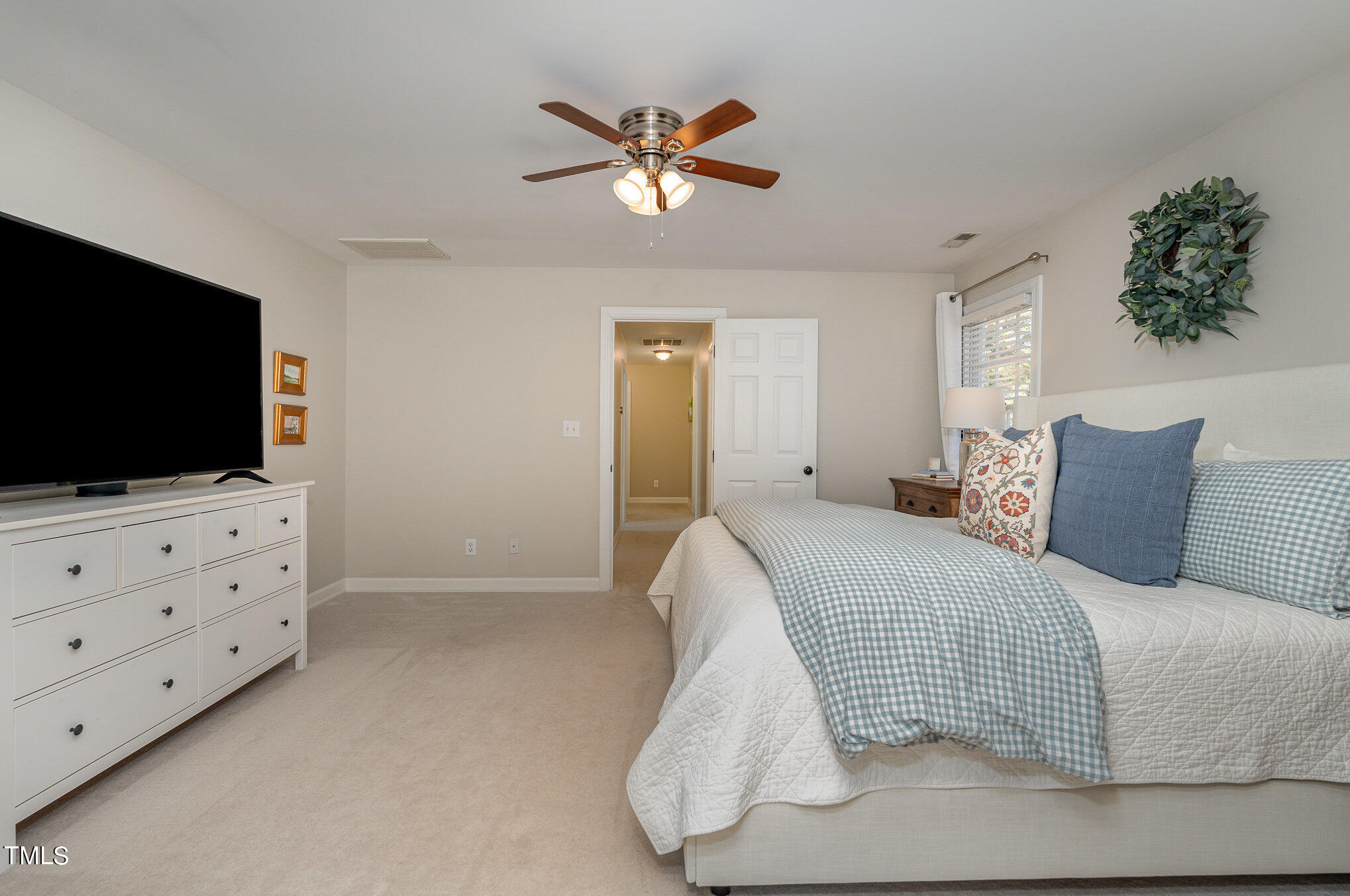 2500 Harptree Court Raleigh, NC 27613 - Photo 25 of 44 a bedroom with a bed and a flat screen tv