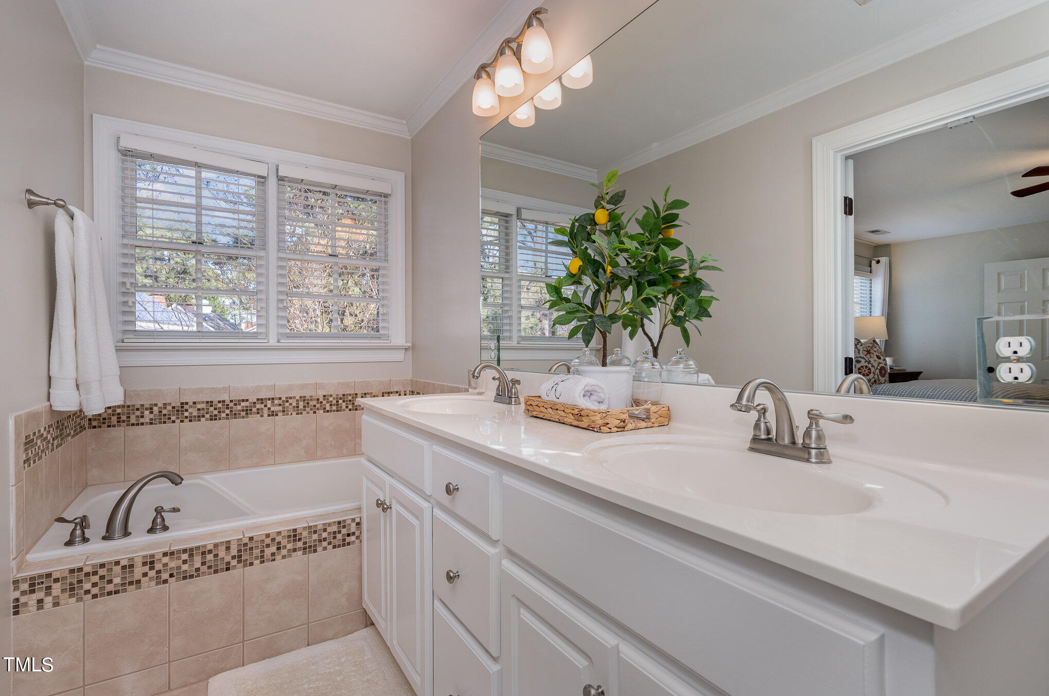 2500 Harptree Court Raleigh, NC 27613 - Photo 26 of 44 a bathroom with a tub a sink and mirror