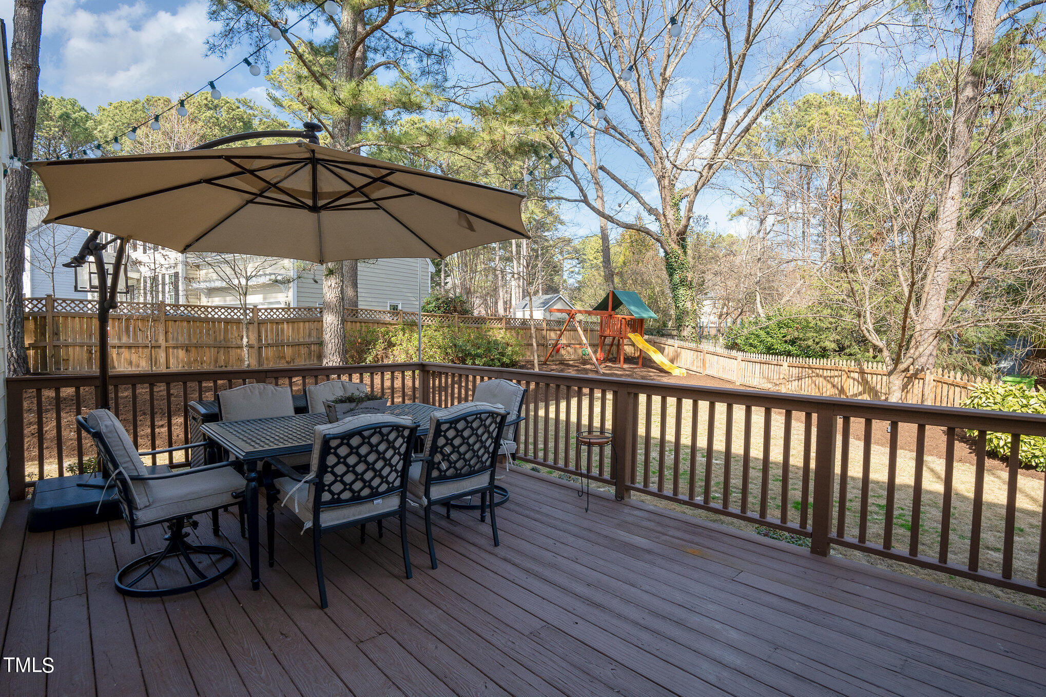 2500 Harptree Court Raleigh, NC 27613 - Photo 33 of 44 a view of deck with table and chairs under an umbrella with wooden floor