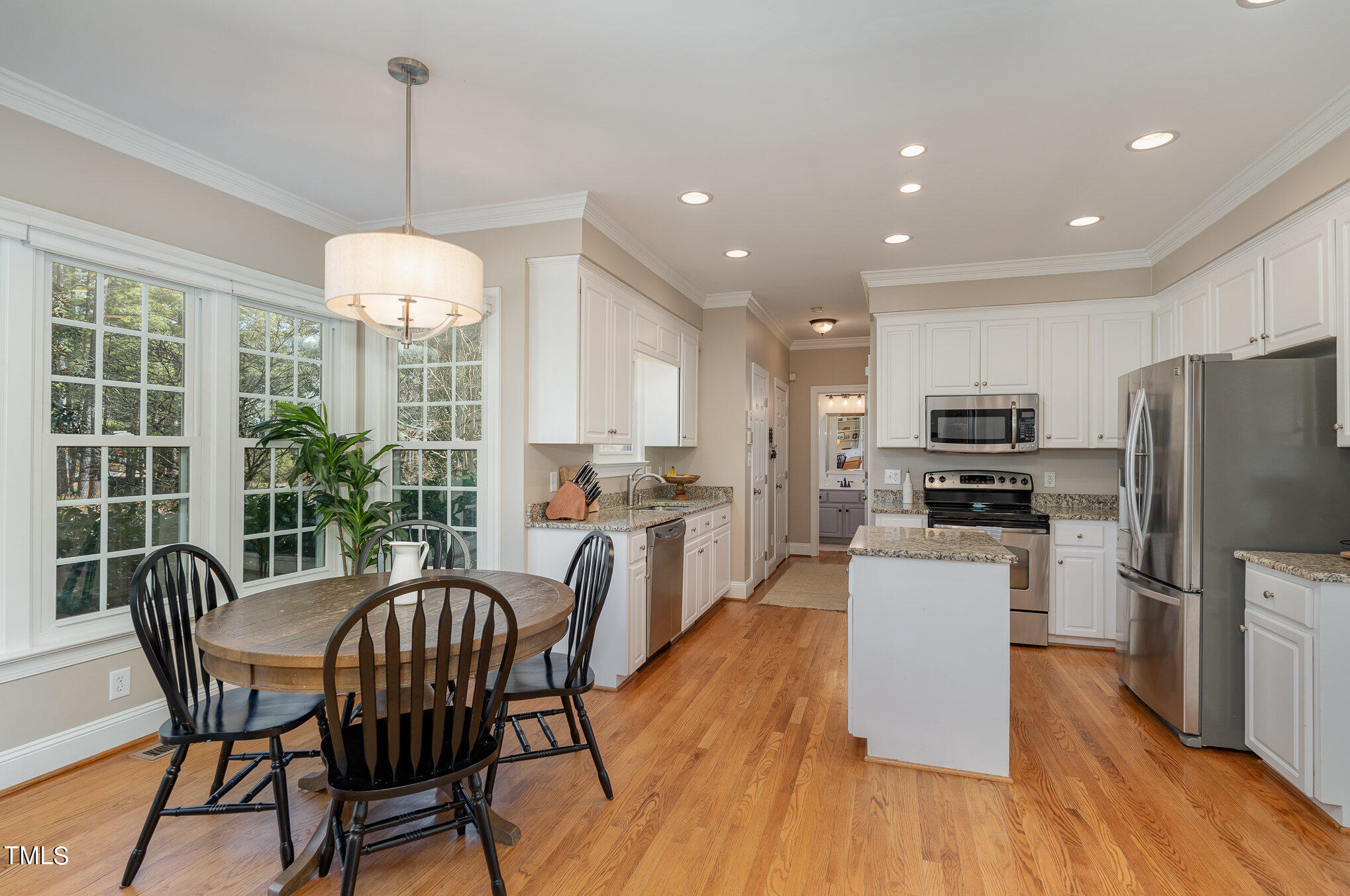 2500 Harptree Court Raleigh, NC 27613 - Photo 6 of 44 a view of a dining room and livingroom with furniture wooden floor a chandelier