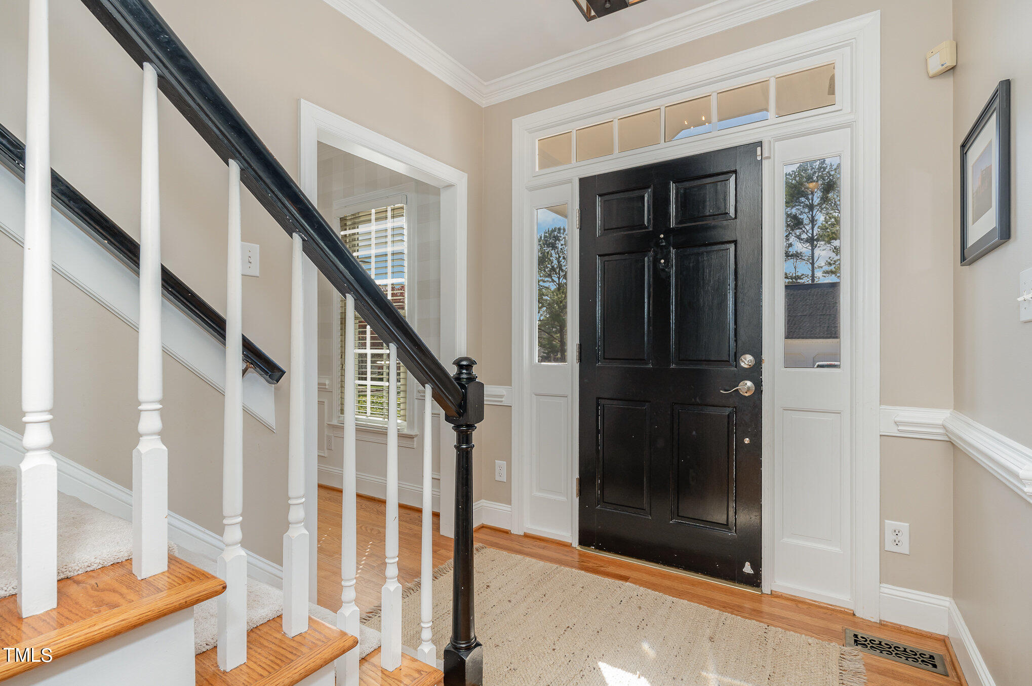 2500 Harptree Court Raleigh, NC 27613 - Photo 10 of 44 a view of staircase with wooden floor and a front door