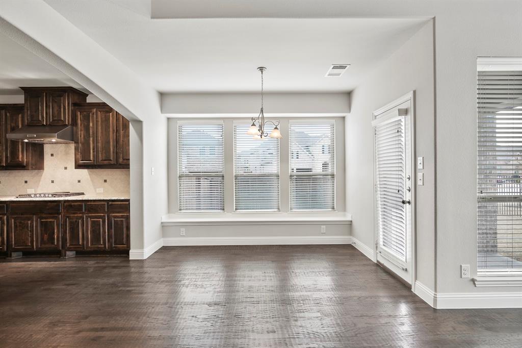 4333 Falcon Lane Carrollton, TX 75010 - Photo 12 of 35 a view of an empty room with a window and wooden floor