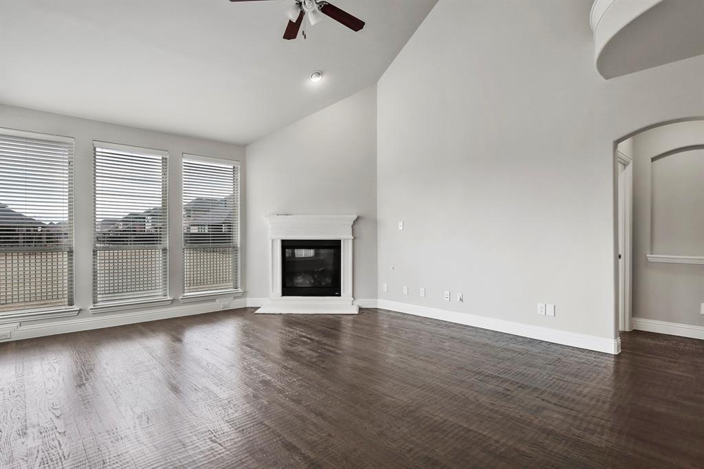 4333 Falcon Lane Carrollton, TX 75010 - Photo 13 of 35 an empty room with wooden floor and windows
