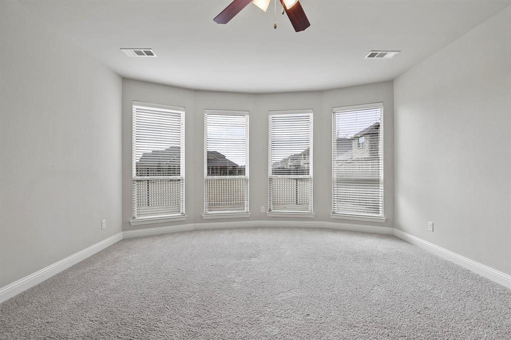4333 Falcon Lane Carrollton, TX 75010 - Photo 17 of 35 an empty room with chandelier fan and windows