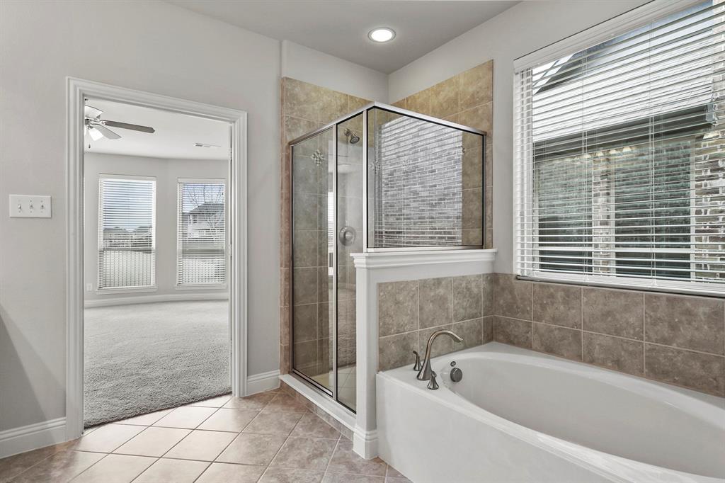 4333 Falcon Lane Carrollton, TX 75010 - Photo 19 of 35 a bathroom with a bathtub and shower