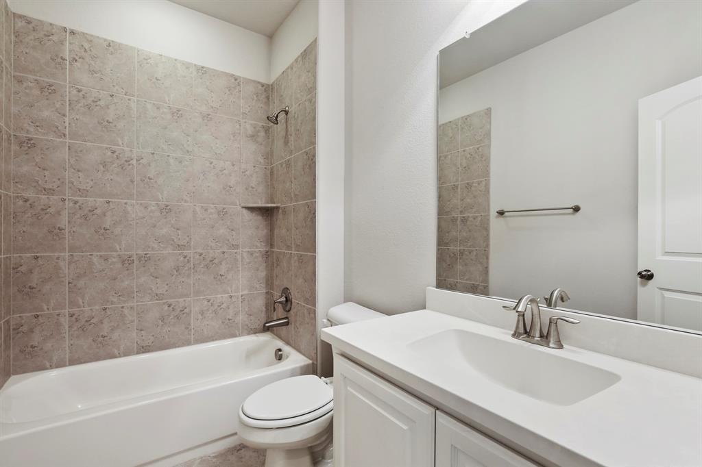 4333 Falcon Lane Carrollton, TX 75010 - Photo 21 of 35 a bathroom with a sink toilet and shower