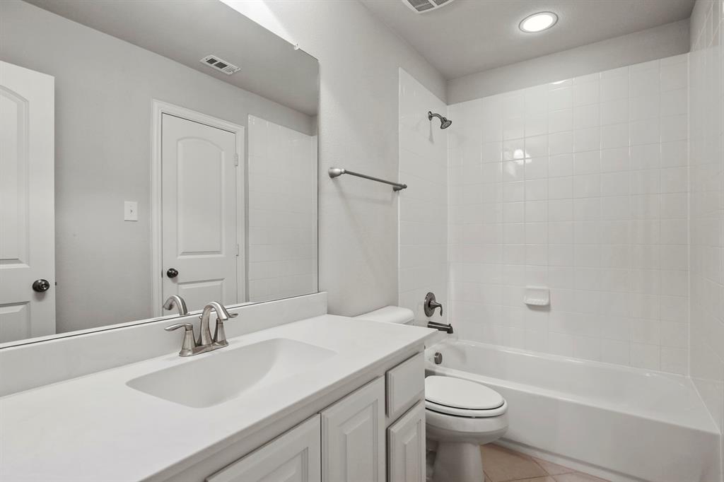 4333 Falcon Lane Carrollton, TX 75010 - Photo 28 of 35 a bathroom with a sink a toilet and shower