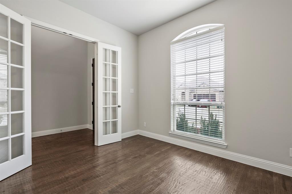 4333 Falcon Lane Carrollton, TX 75010 - Photo 4 of 35 an empty room with wooden floor and windows