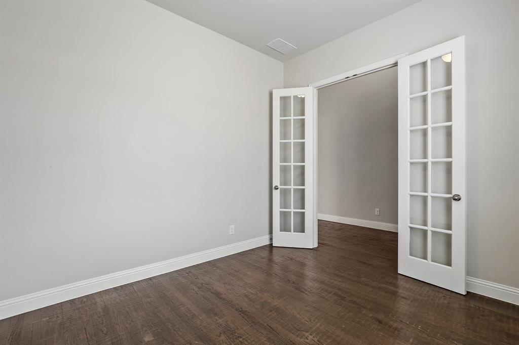4333 Falcon Lane Carrollton, TX 75010 - Photo 5 of 35 an empty room with wooden floor and windows