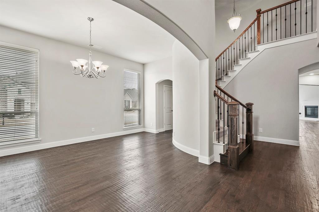4333 Falcon Lane Carrollton, TX 75010 - Photo 6 of 35 a view of a hallway with wooden floor and stairs