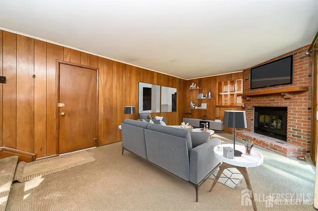 a living room with furniture a fireplace and a flat screen tv