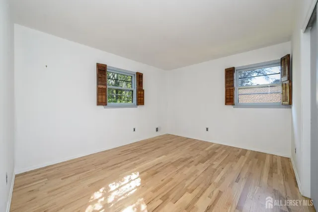 a view of room with window and hardwood floor